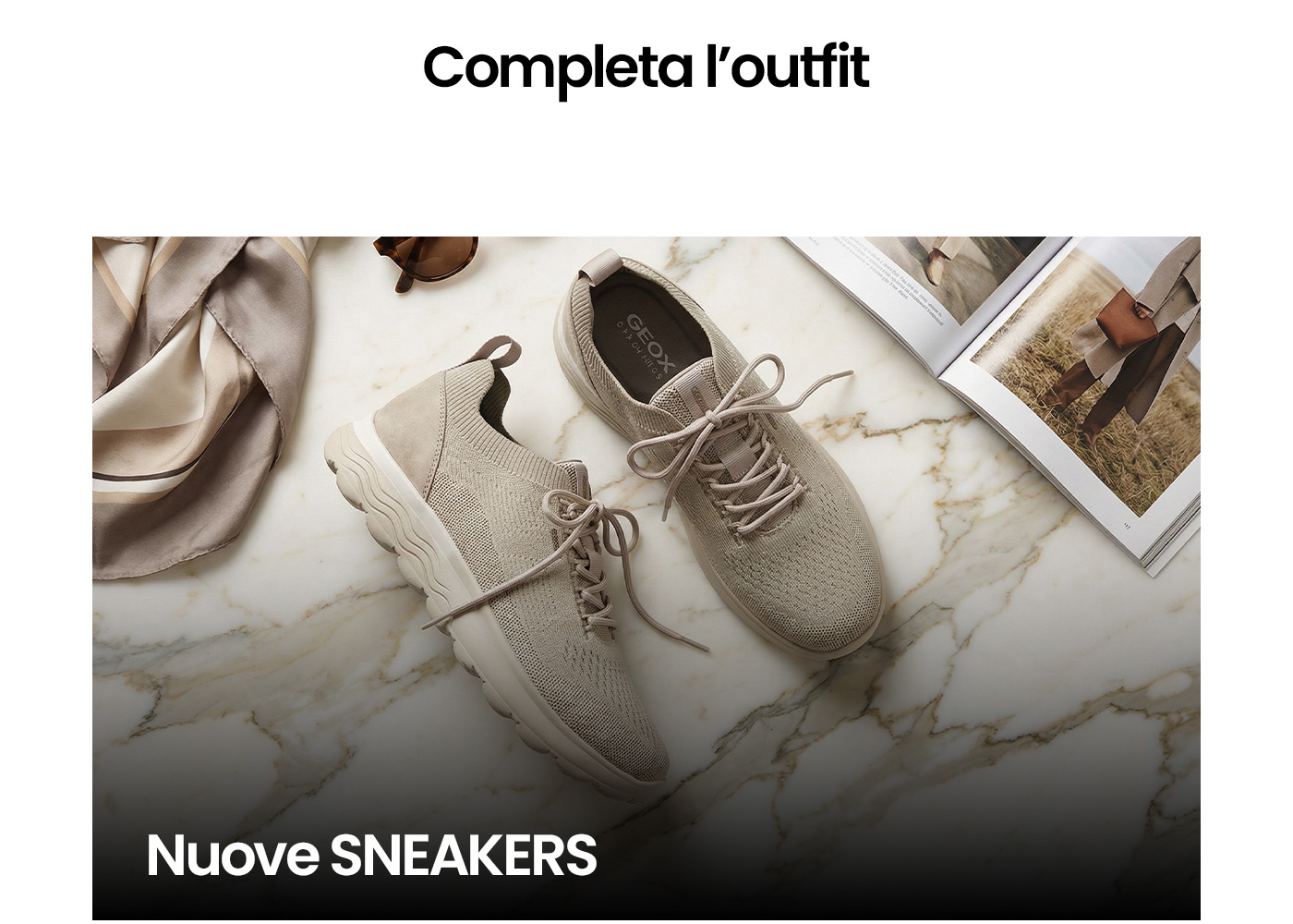 Beige knit women's sneakers on marble surface beside a silk scarf, sunglasses and an open fashion magazine