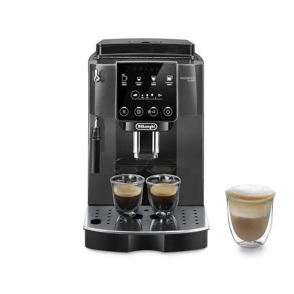 Black De'Longhi Magnifica S Smart super-automatic espresso machine with two espresso cups on drip tray and a frothy latte in a double-walled glass beside