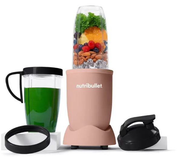 Nutribullet blender in rose pink with cup of fruit, nuts and greens, plus travel cup, lids and green smoothie