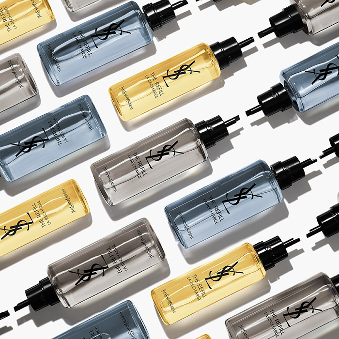 Un pattern di ricariche per profumo YSL in tonalit&agrave; blu, oro e grigio su sfondo bianco.