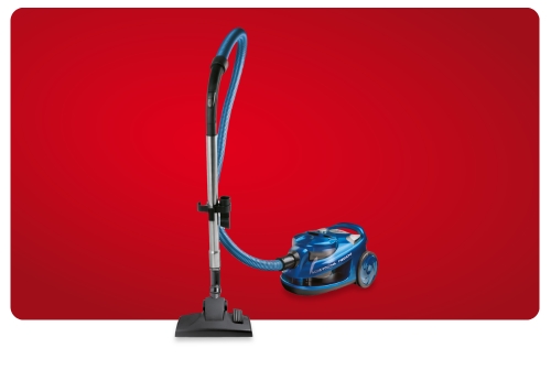 Blue canister vacuum cleaner with flexible hose and floor nozzle against a red background