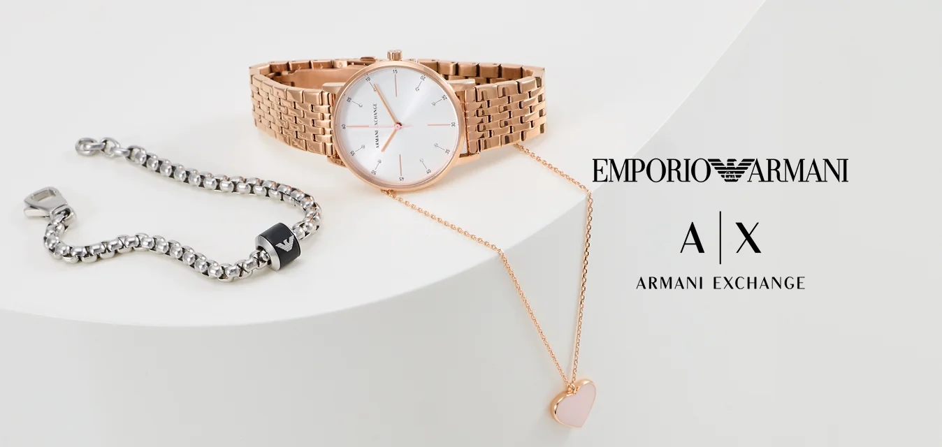 Orologio in oro rosa con cinturino a rete e quadrante bianco, bracciale in argento con accento nero, e collana con pendente a forma di cuore in oro rosa.