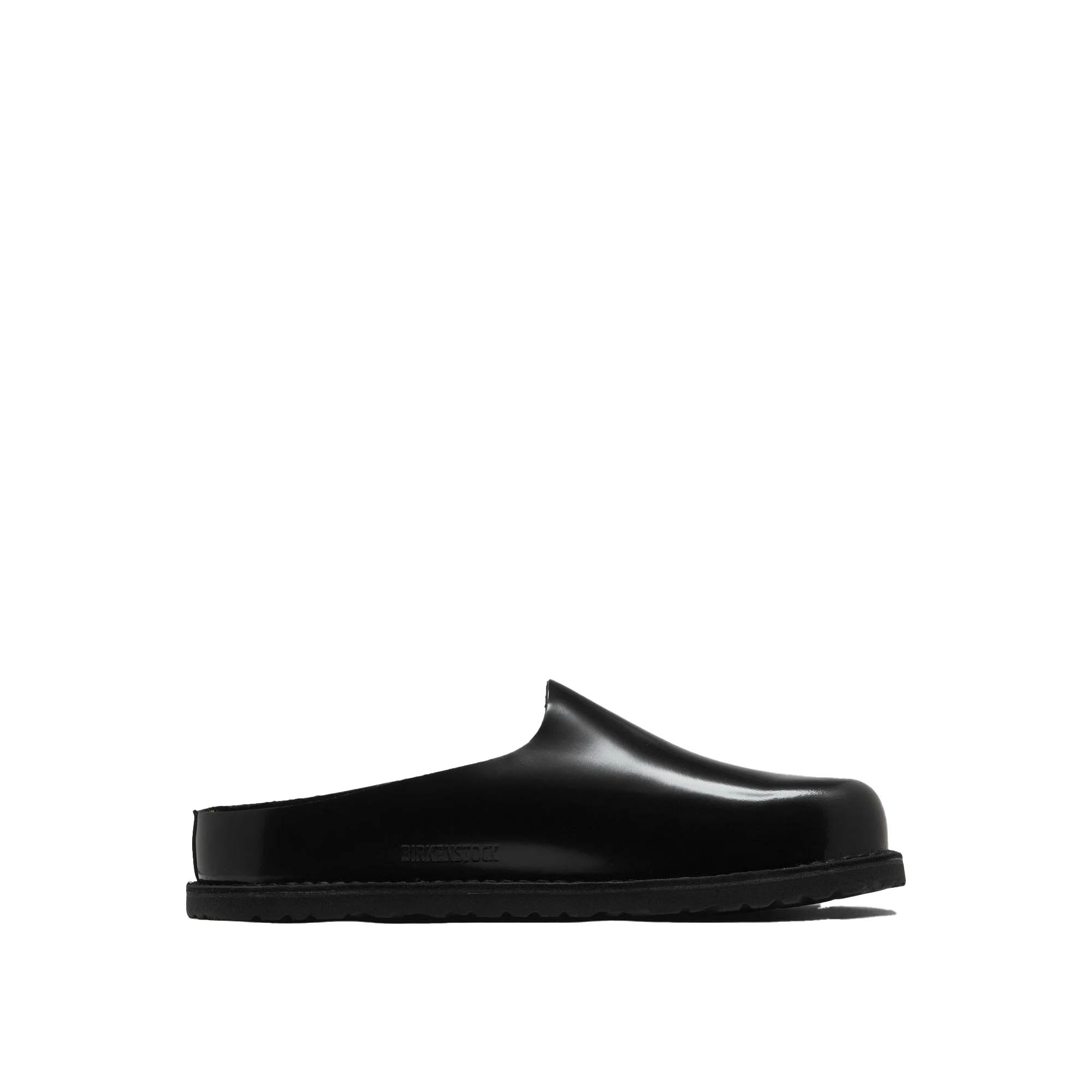 Black glossy leather slip-on mule clog with contoured footbed and textured sole on white background