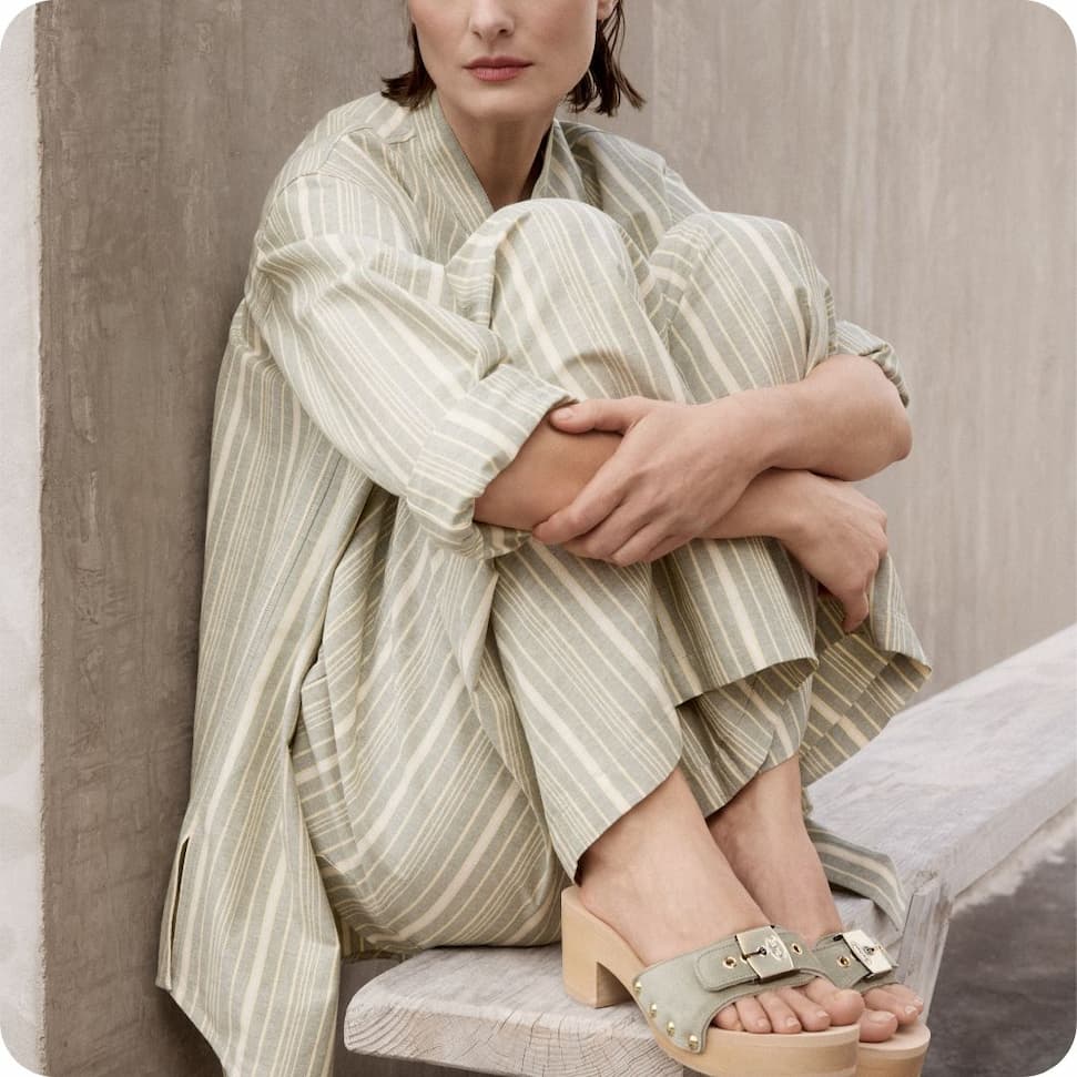 an image of a person sitting on a bench looking out at the ocean
