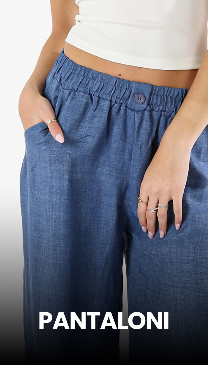 Blue linen wide‑leg trousers with elasticated waistband and button, model in white crop top with hands in pockets