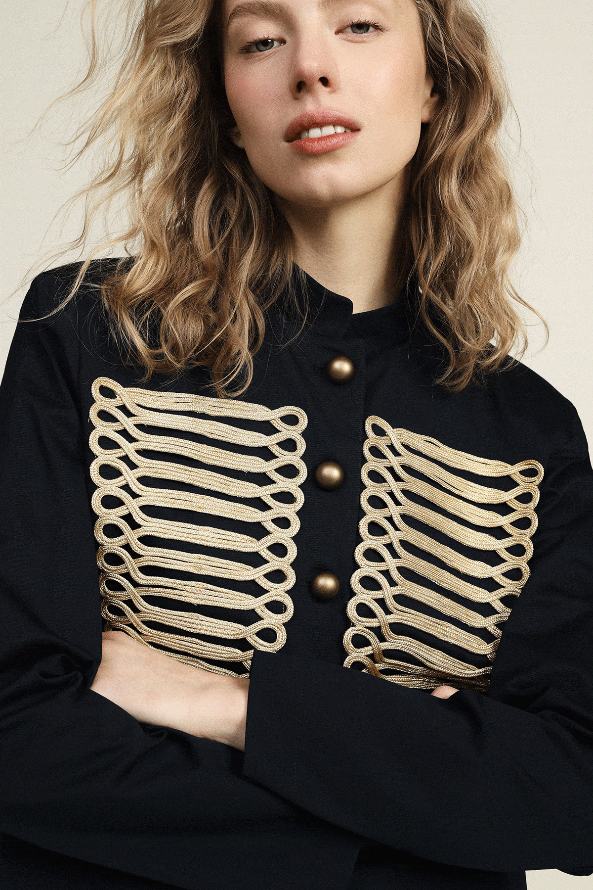 Woman model wearing beige and black lace-trim midi skirt with black blazer; also shown in a beige robe-style jacket with black trim and belt