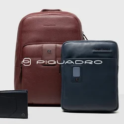 Zaino in pelle bordeaux, borsa per laptop in pelle blu navy e portafoglio nero. Tutti gli articoli presentano design eleganti e texture morbide.