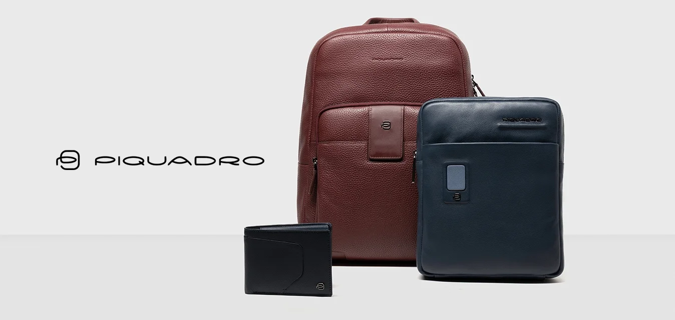 Zaino in pelle bordeaux, borsa per laptop in pelle blu navy e portafoglio nero. Tutti gli articoli presentano design eleganti e texture morbide.