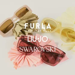 Tre paia di occhiali da sole beige, giallo e rosa, ciascuno appoggiato su un fiore di carta stropicciata abbinato su uno sfondo chiaro.