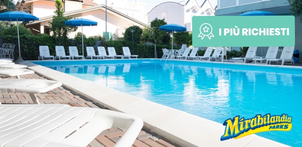 Outdoor hotel-style swimming pool with blue sun umbrellas, white sun loungers lined along the deck and Mirabilandia Parks logo.