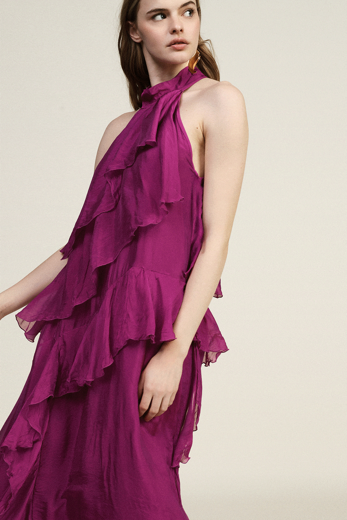 Three women's dresses: magenta ruffled halter gown, mustard wrap-front midi dress with belt, mint V‑neck dress with large pleated floral shoulder detail