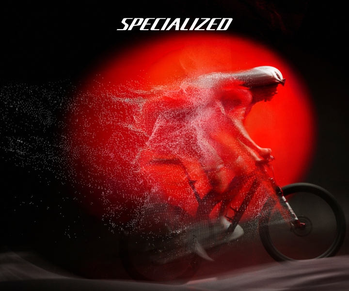 Specialized logo above silhouette of cyclist on road bike with red motion trail, speed and performance.