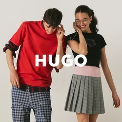 Ragazzo e ragazza adolescenti condividono le cuffie, stanno vicini, sorridono; lui indossa una camicia rossa e pantaloni a quadri, lei una canotta nera e una gonna grigia.