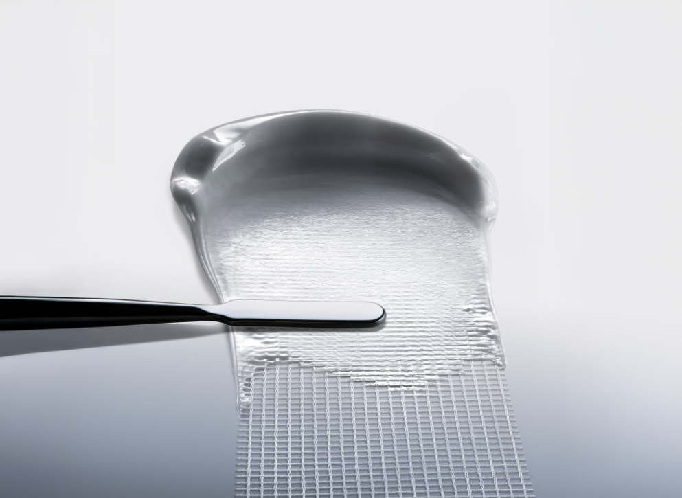 White, airy and breathable texture of the new Bandage formula scooped by a metallic spatula.