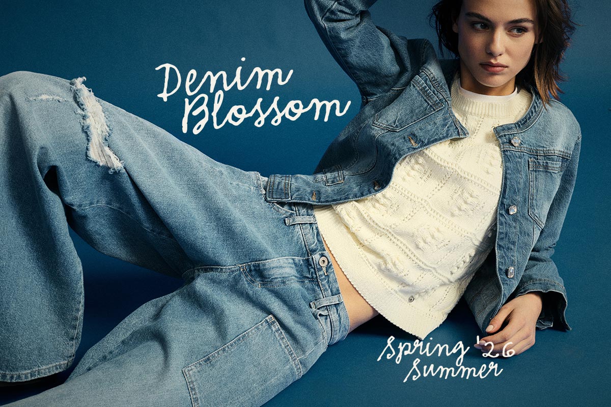 Young woman reclining in blue denim jacket and ripped jeans over a cream knit jumper against a blue backdrop with 'Denim Blossom' text