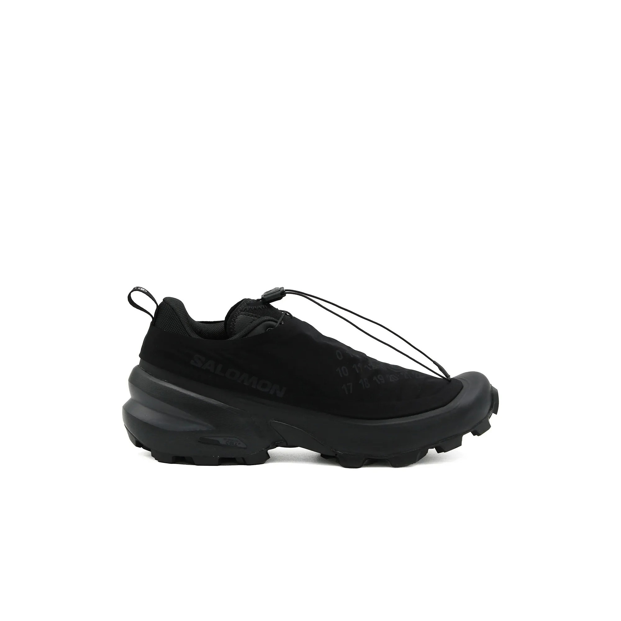 Side view of black Salomon low-top trail shoe with quicklace fastening, pull tab and chunky tread sole
