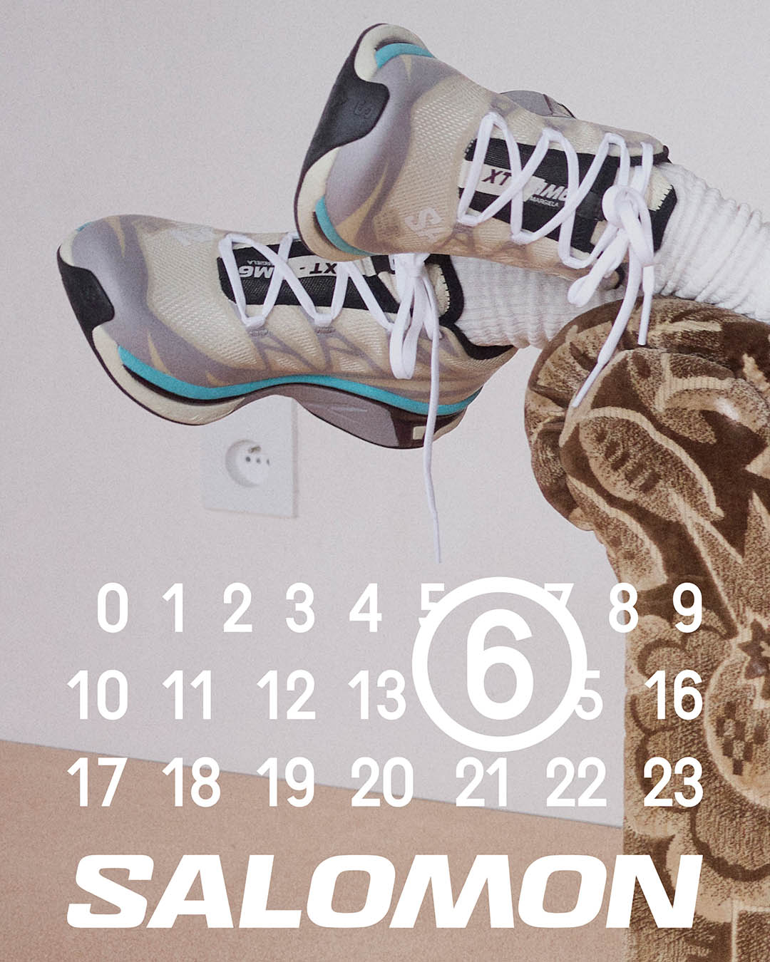 Beige-grey Salomon trainers with turquoise accents, white socks and patterned trousers; calendar overlay showing circled 6 and SALOMON logo