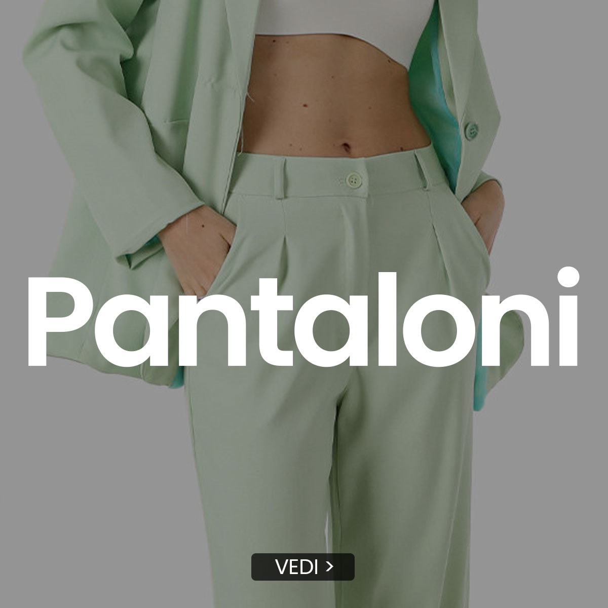 Cropped view of model wearing mint-green tailored trousers and matching blazer with hands in pockets and white crop top, overlay text 'Pantaloni'.
