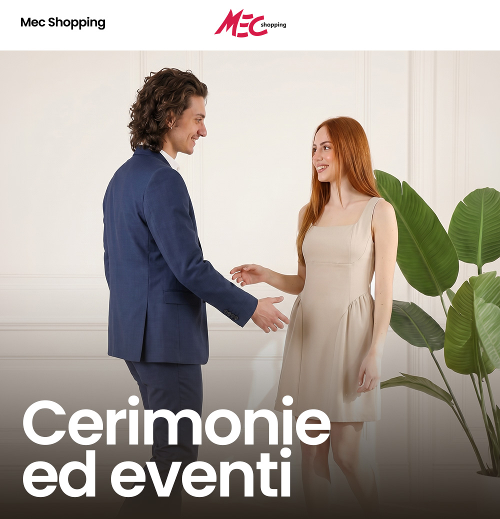 Smiling man in a navy suit and woman in a beige dress greeting in an elegant room with large green plants—formalwear for ceremonies and events