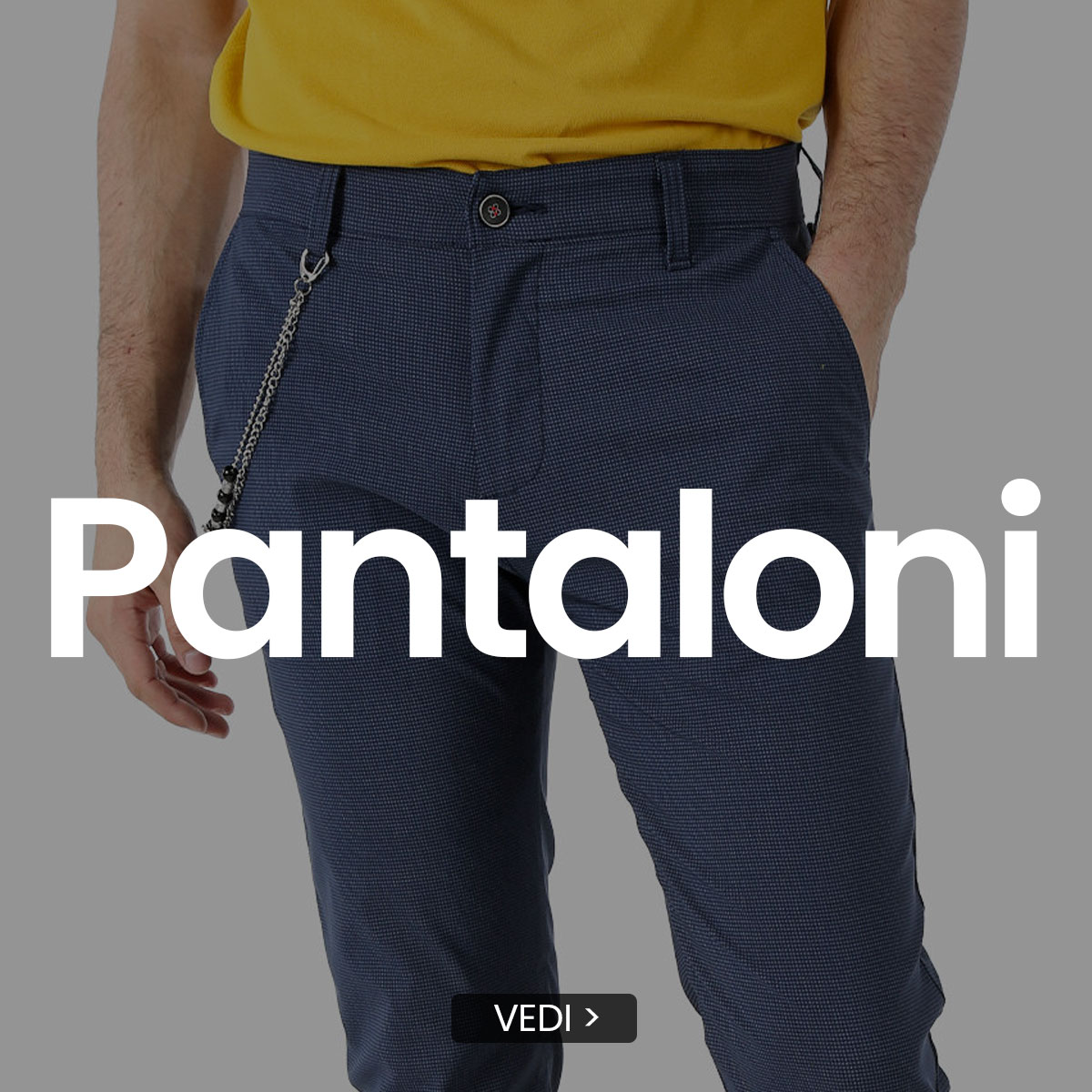 Men's navy textured trousers (chinos) with side pocket chain, model wearing a yellow top and hands in pockets