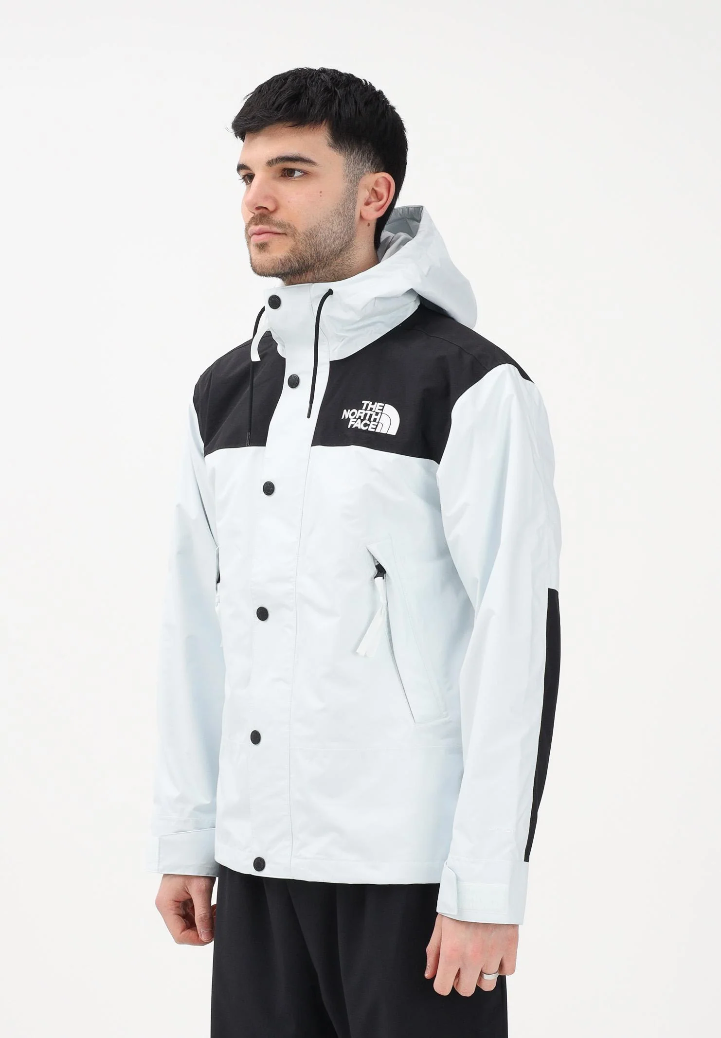 Image of THE NORTH FACE Giacca a vento Reign On celeste e nera da uomo