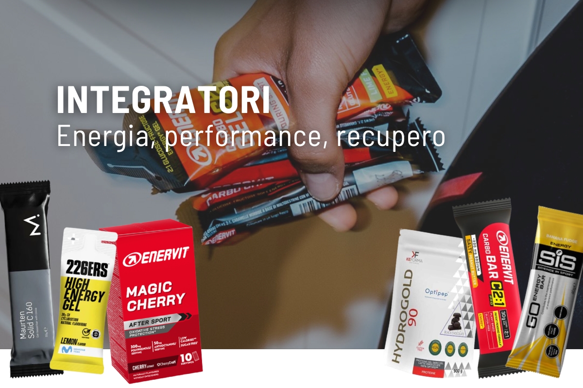 Hand holding assorted energy bars and sports supplements labelled for performance, energy and recovery