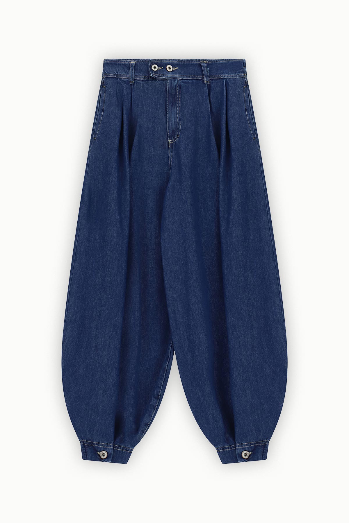 High-waisted navy denim balloon trousers with front pleats, belt loops, zip fly and buttoned ankle cuffs
