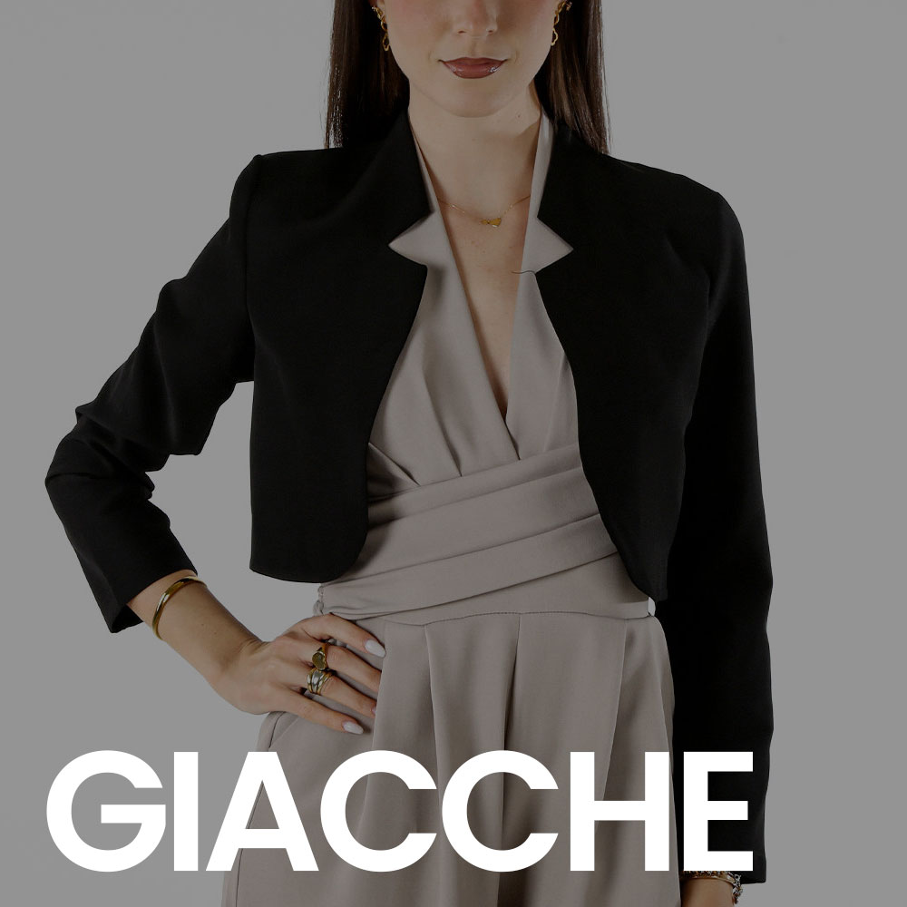 Cropped model torso wearing a black cropped blazer over a grey wrap dress, hand on hip with rings and bracelet, 'GIACCHE' logo overlay