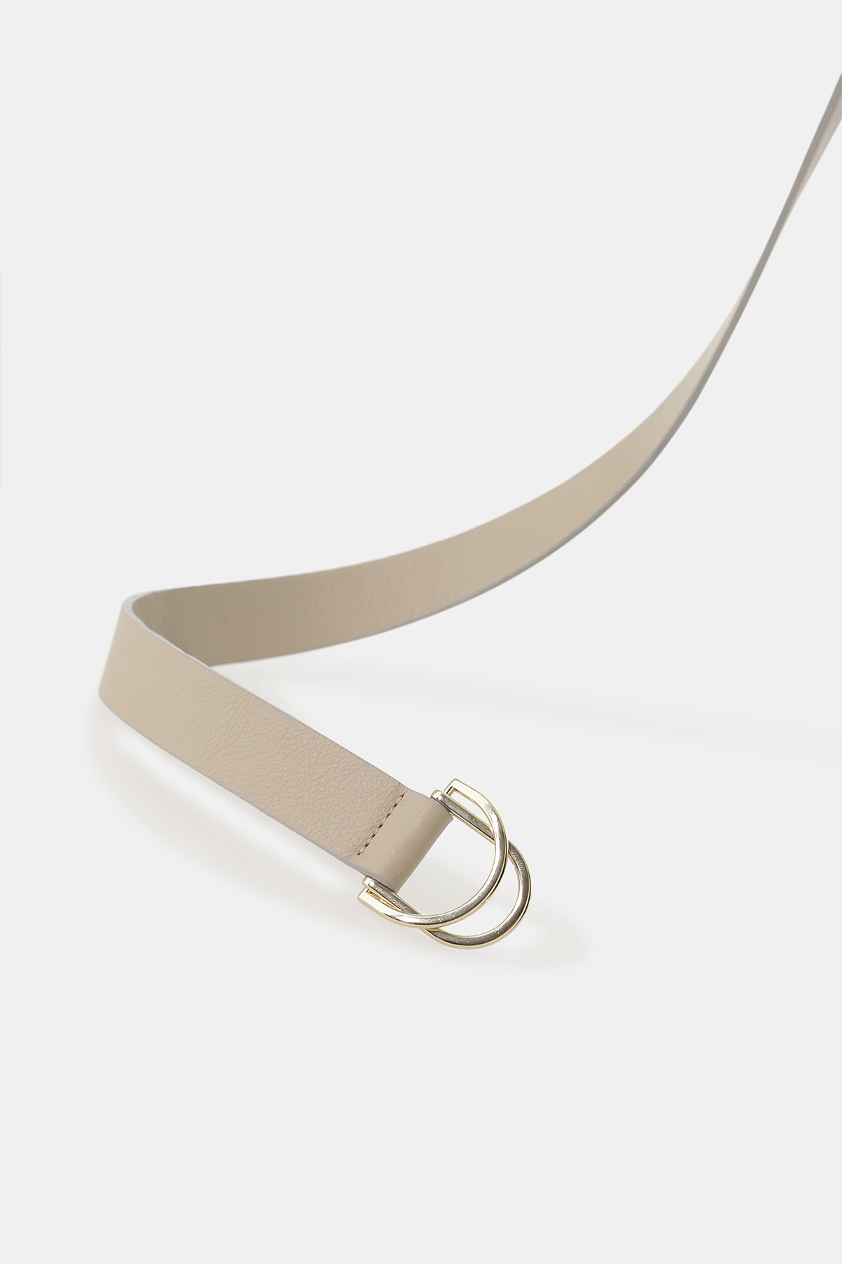 Beige leather belt with gold double-ring buckle on white background, minimalist fashion accessory