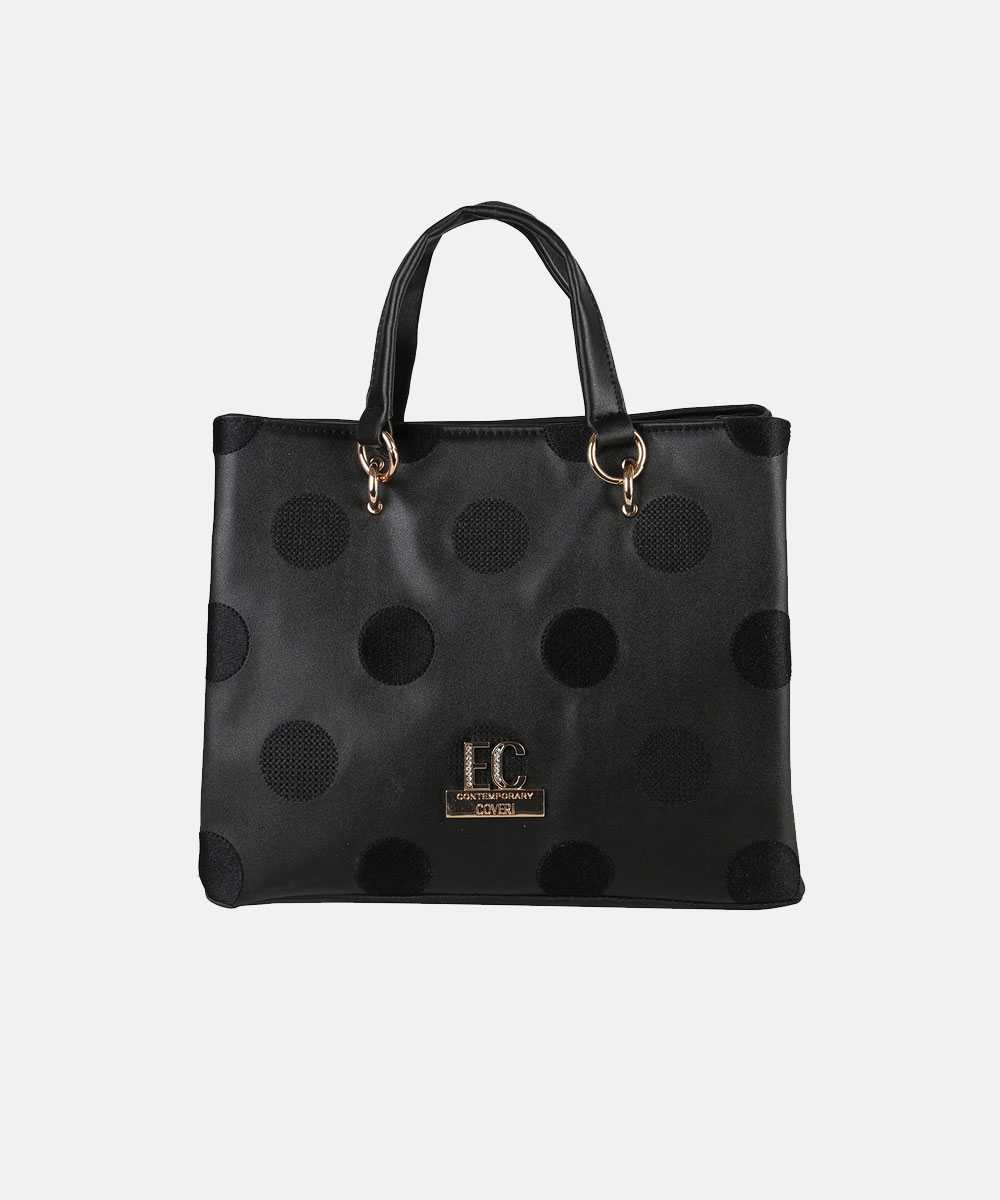 Black satin tote bag with large textured polka dots, double top handles, gold ring hardware and small gold logo plaque