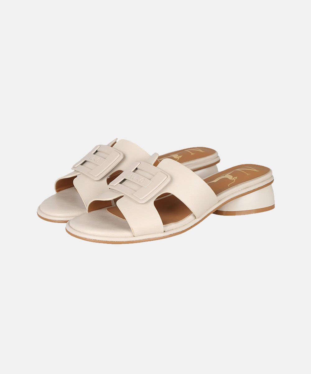 Cream leather open-toe slide sandals with wide straps, oversized square buckles and low block heels