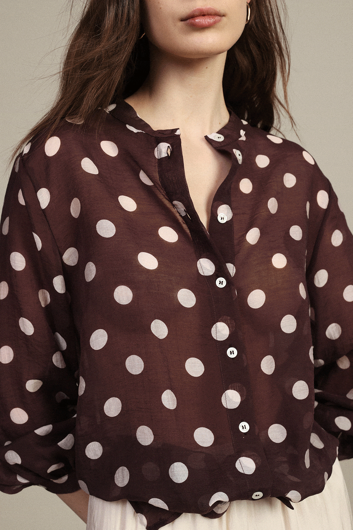 Collage of women’s brown and white polka dot clothing: button blouse, pencil skirt, halter dress and wide‑leg trousers