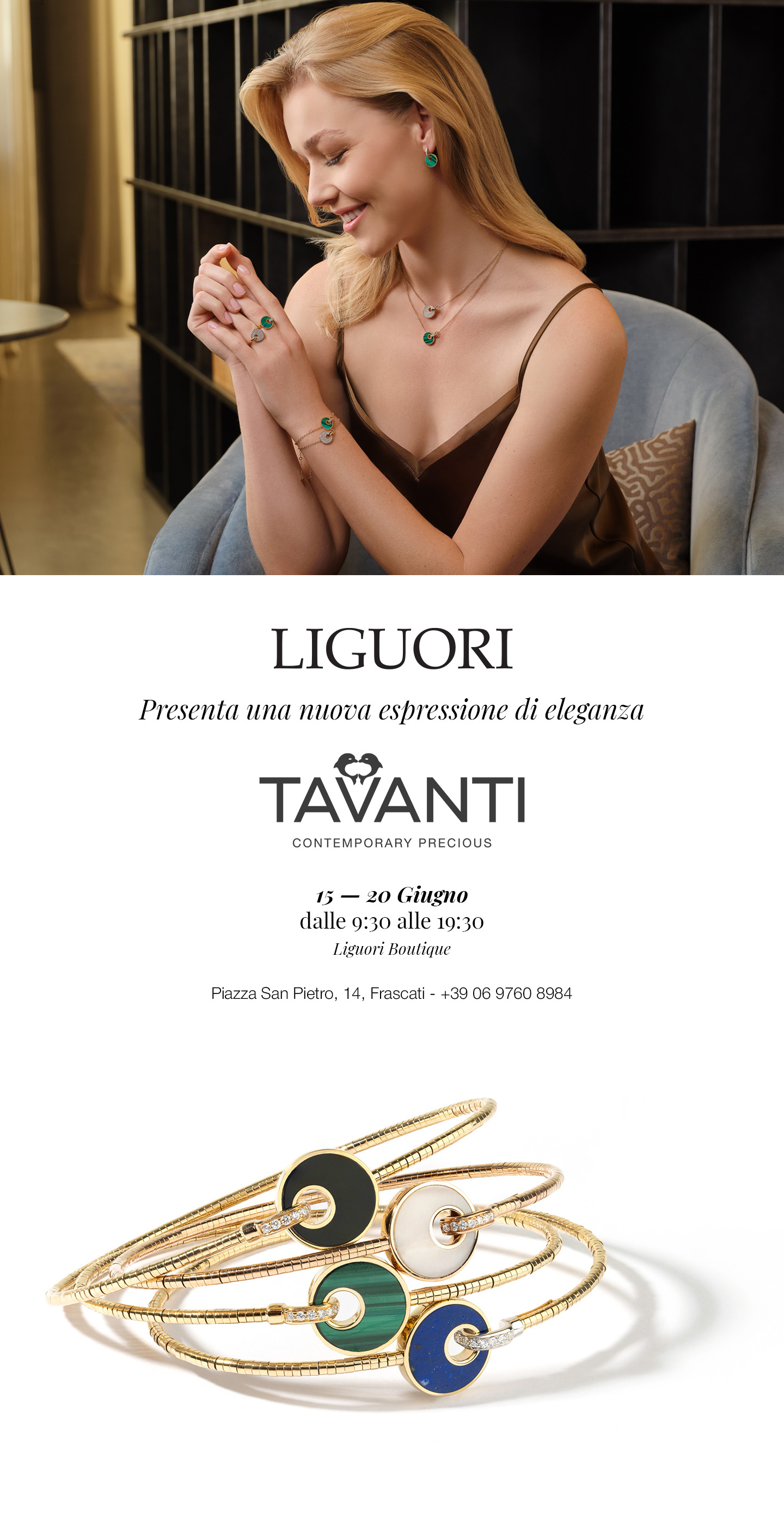 Smiling model wearing Liguori Tavanti emerald pendant, earrings and rings, seated above gold bangles with coloured enamel discs jewellery