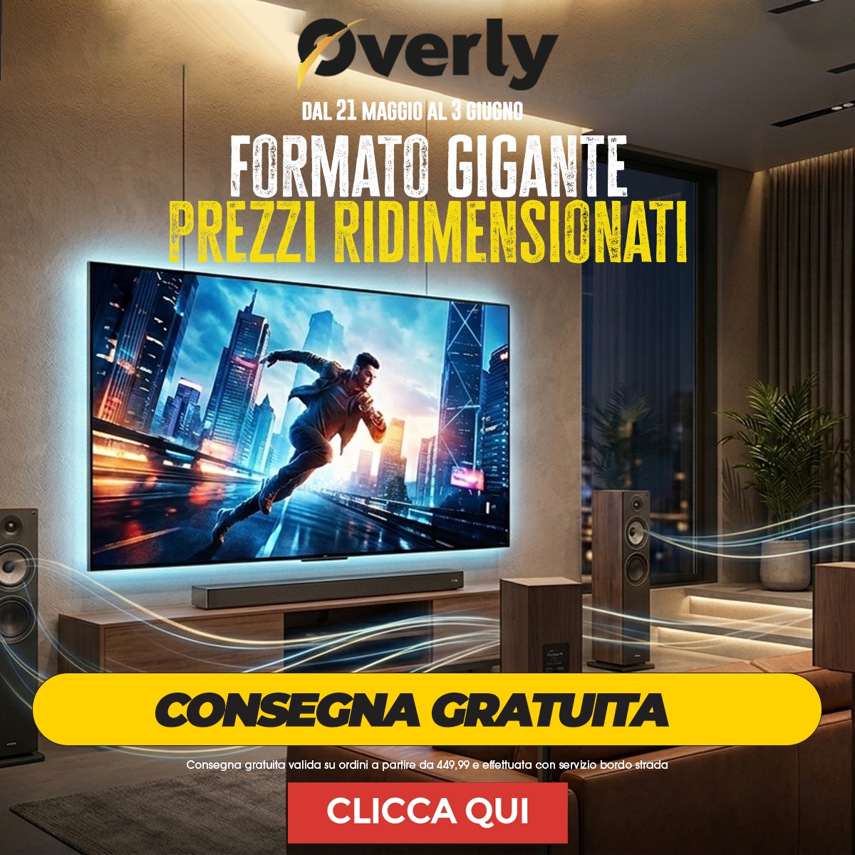 Modern living room with large wall-mounted TV displaying an action scene, floorstanding speakers and yellow 'Consegna gratuita' promotional banner