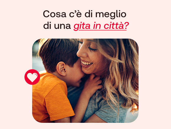 “Donna sorridente abbraccia un bambino all’aperto. Testo: ‘Cosa c’è di meglio di una gita in città?’ con icona a forma di cuore.” “Donna sorridente abbraccia un bambino all’aperto. Testo: ‘Cosa c’è di meglio di una gita in città?’ con icona a forma di cuore.”
