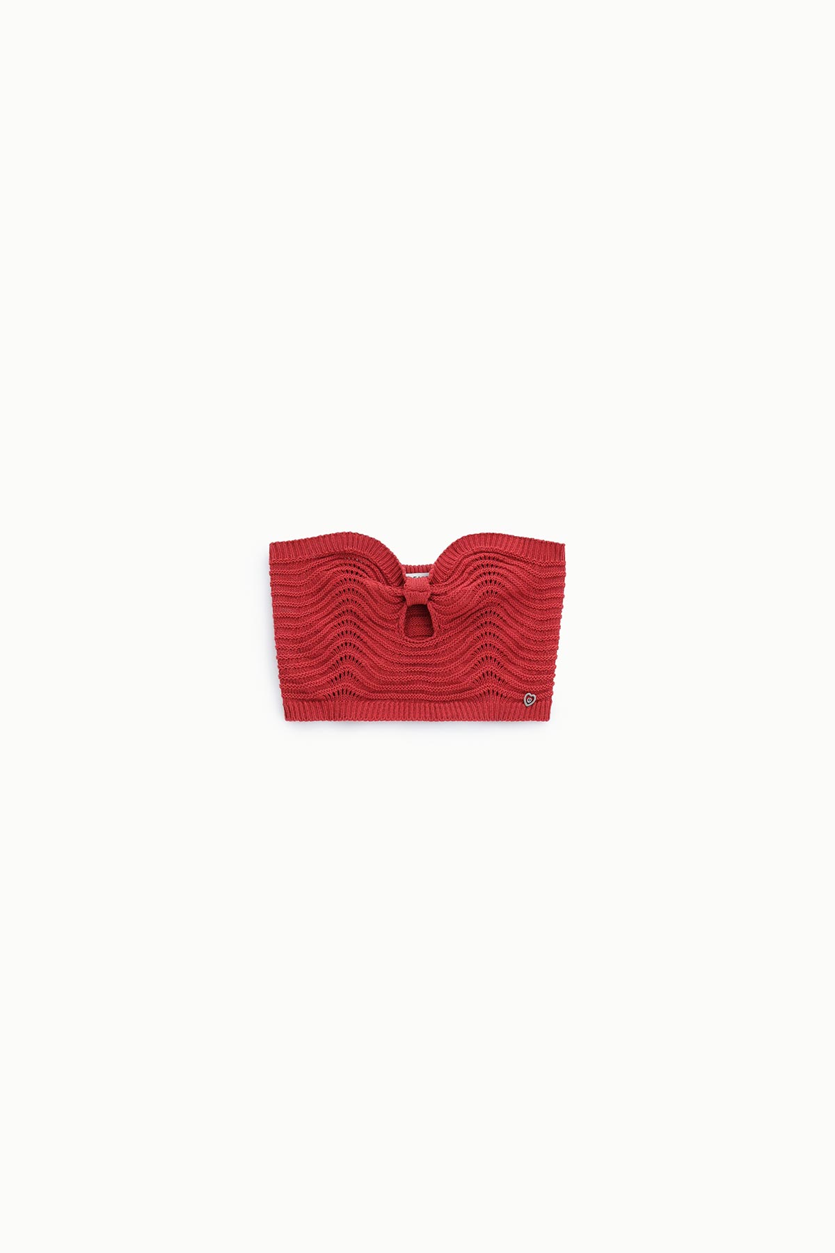 Red crocheted strapless bandeau top with scalloped wave pattern and small metal logo on white background