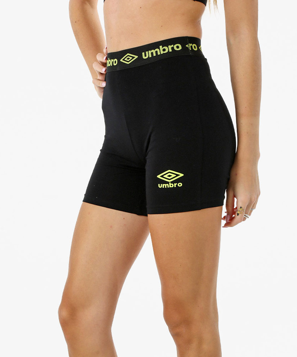 Black high-waist fitted Umbro sports shorts with neon-yellow logo on thigh and branded elastic waistband, model shown waist-down