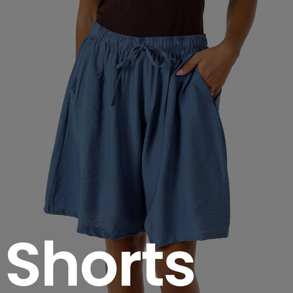Person wearing loose navy drawstring knee-length shorts with elastic waistband and side pockets, casual summer style