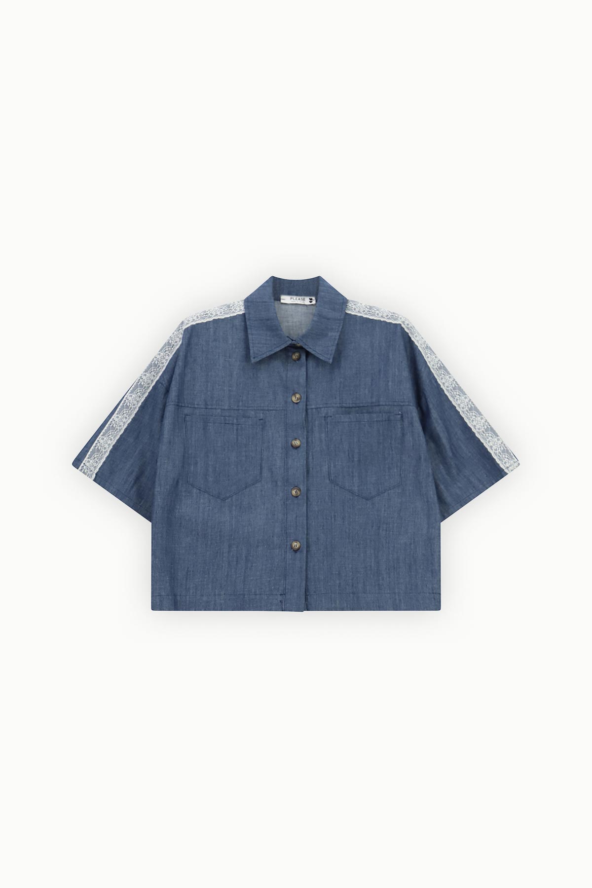 Boxy cropped blue denim short-sleeve shirt with button front, chest patch pockets and white lace trim along the shoulders