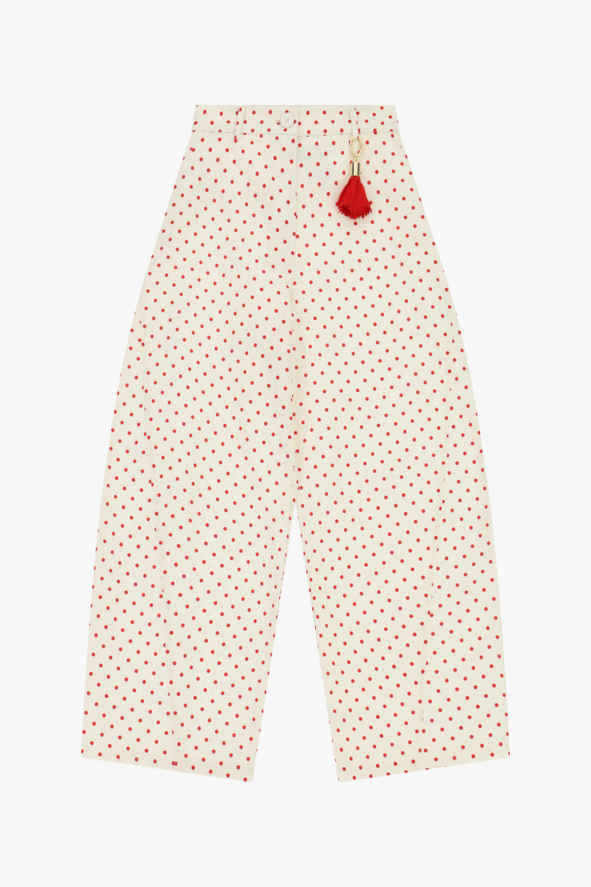 Cream wide-leg trousers with small red polka dots and a red tassel charm at the waist