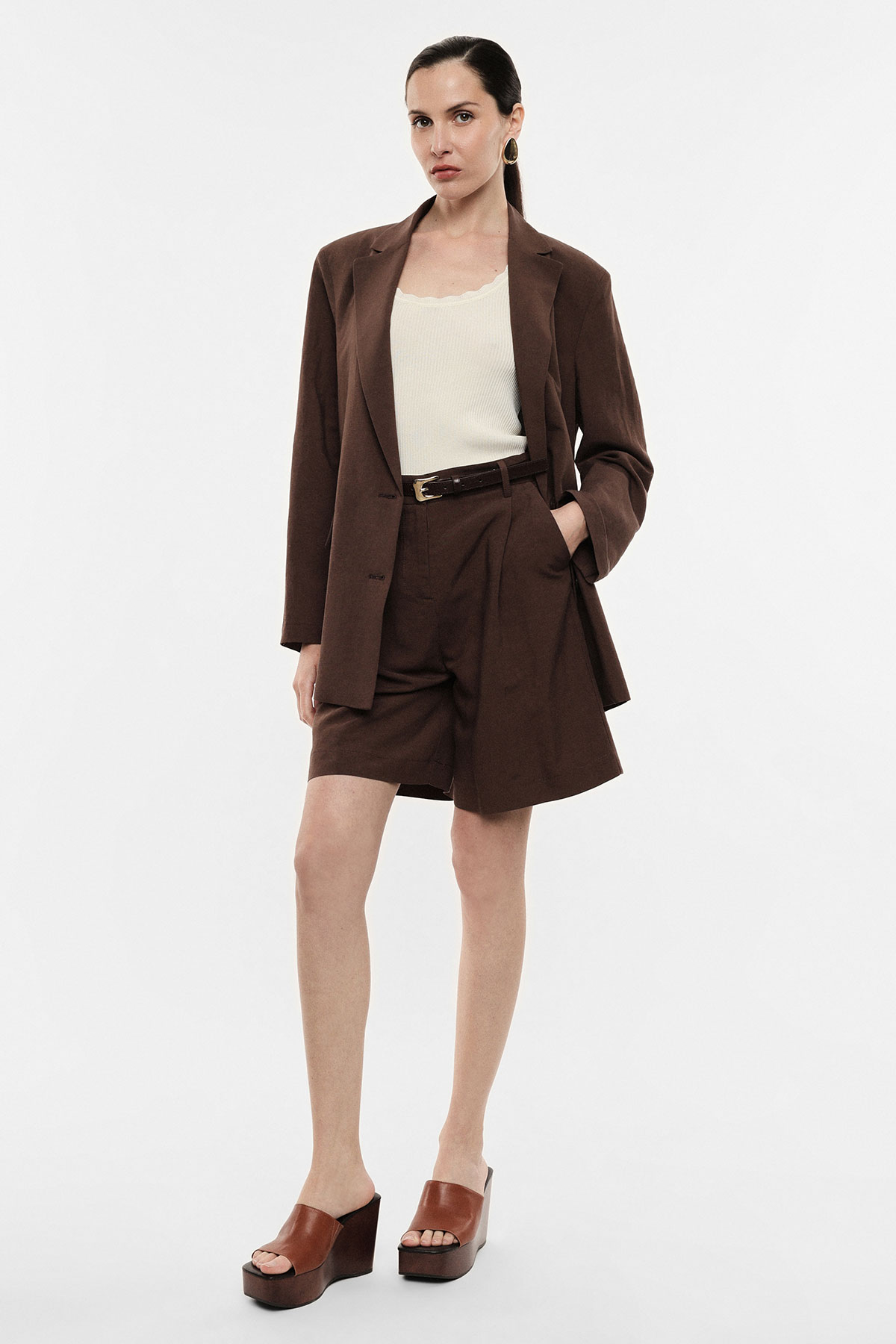 Full-length model in brown blazer and tailored shorts with cream tank, belt and brown platform sandals