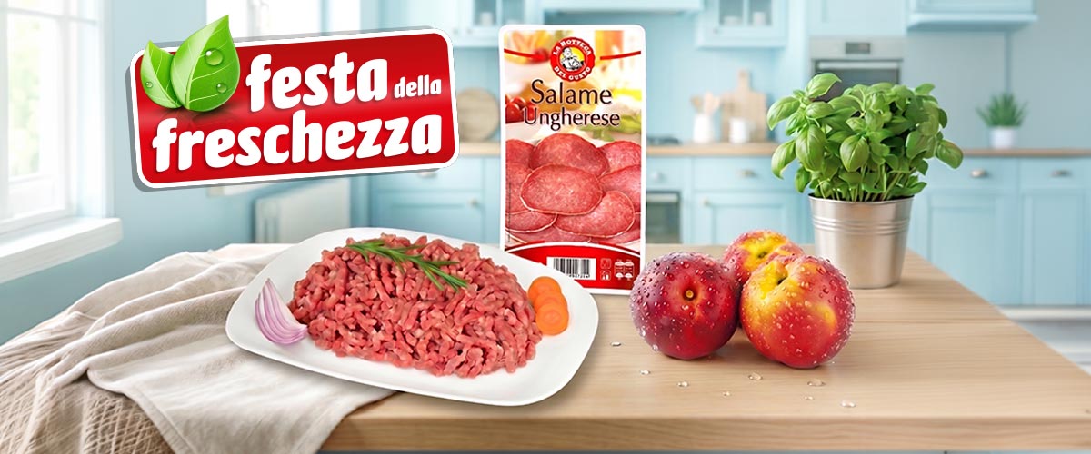 Fresh minced beef on a plate with onion and herbs beside Salame Ungherese pack, two peaches and basil on kitchen counter.