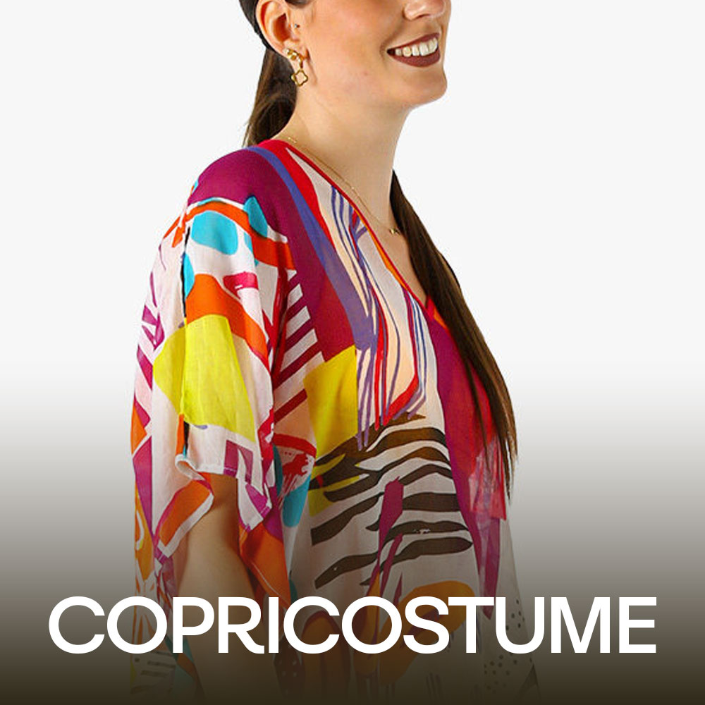 Smiling model wearing colourful abstract print kaftan top with long dark ponytail and geometric gold earrings