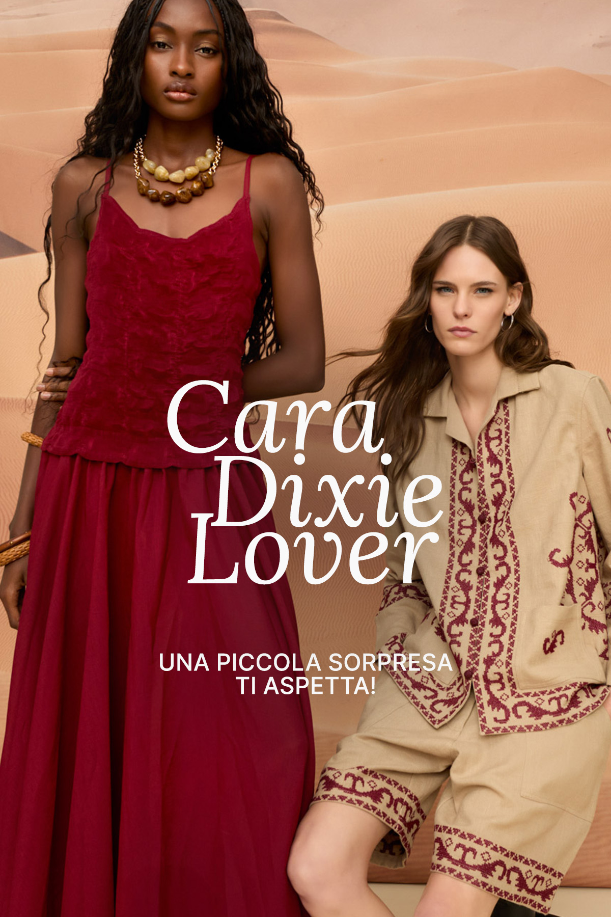 Two models in a desert setting: woman in a burgundy dress and woman in an embroidered beige co-ord, fashion campaign text overlay