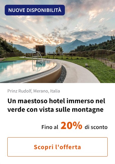 Un maestoso hotel immerso nel verde con vista sulle montagne