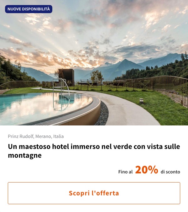 Un maestoso hotel immerso nel verde con vista sulle montagne