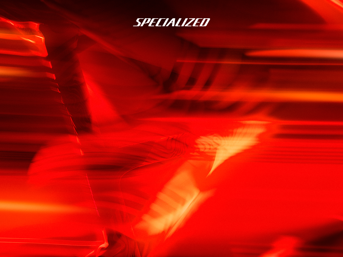 Red abstract motion-blur background with white "SPECIALIZED" logo centred at top