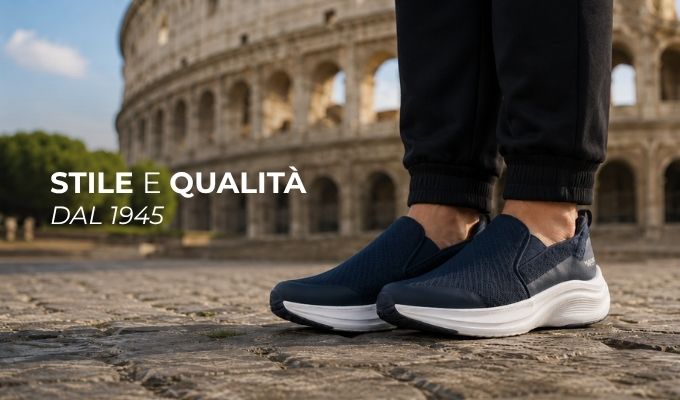 Close-up of navy slip-on sneakers on cobblestones in front of Rome's Colosseum, styled ad text 'Stile e Qualità dal 1945'