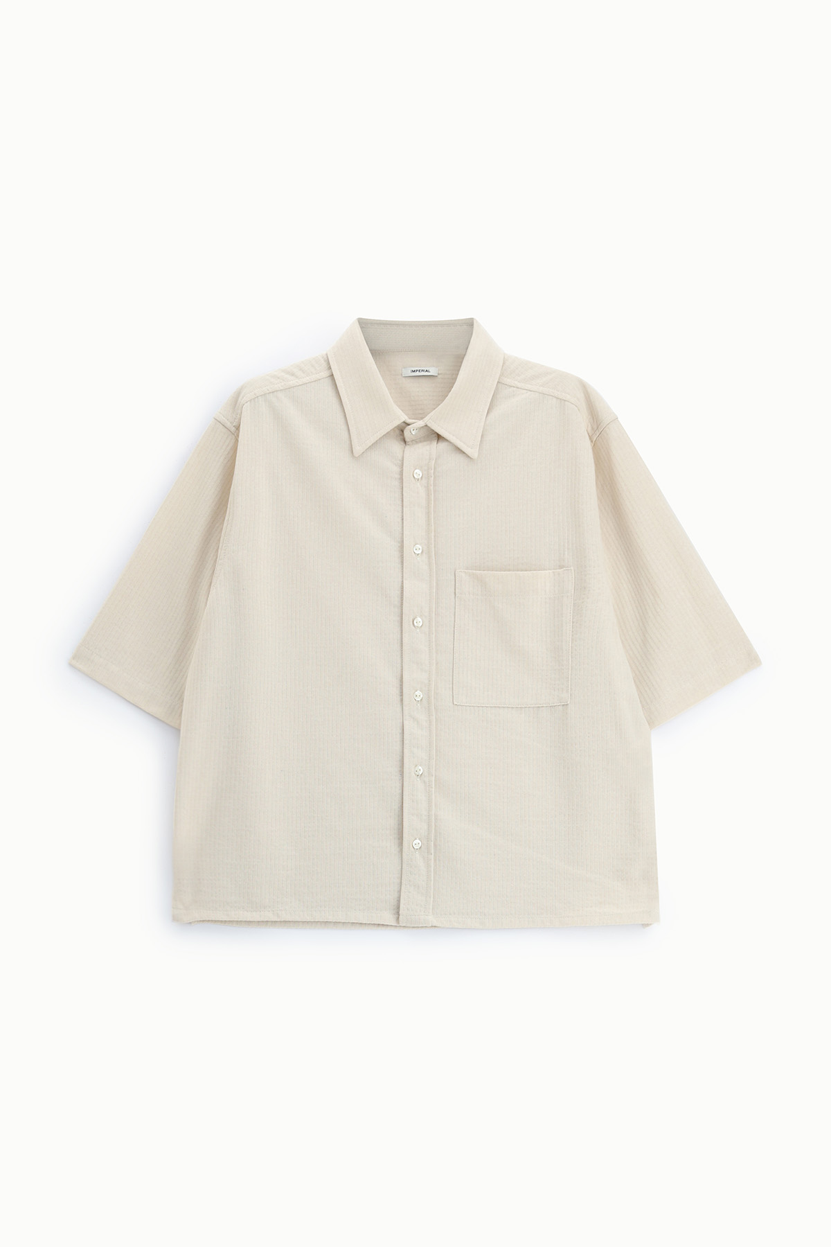 Beige short-sleeve relaxed button-up shirt with spread collar, chest pocket and subtle textured fabric