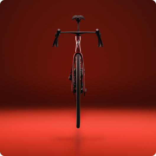 Front view of a red racing road bike with aerodynamic frame and drop handlebars on a red studio background